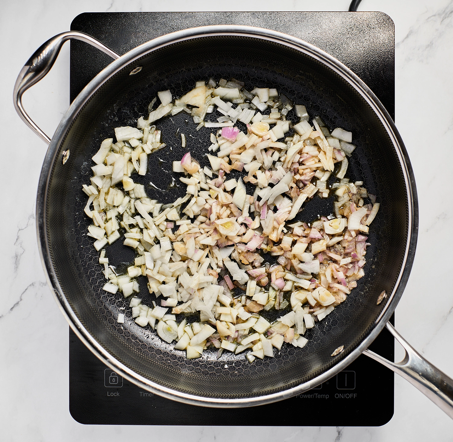 Diced shallot and onion and sautéed until softened in a pan.