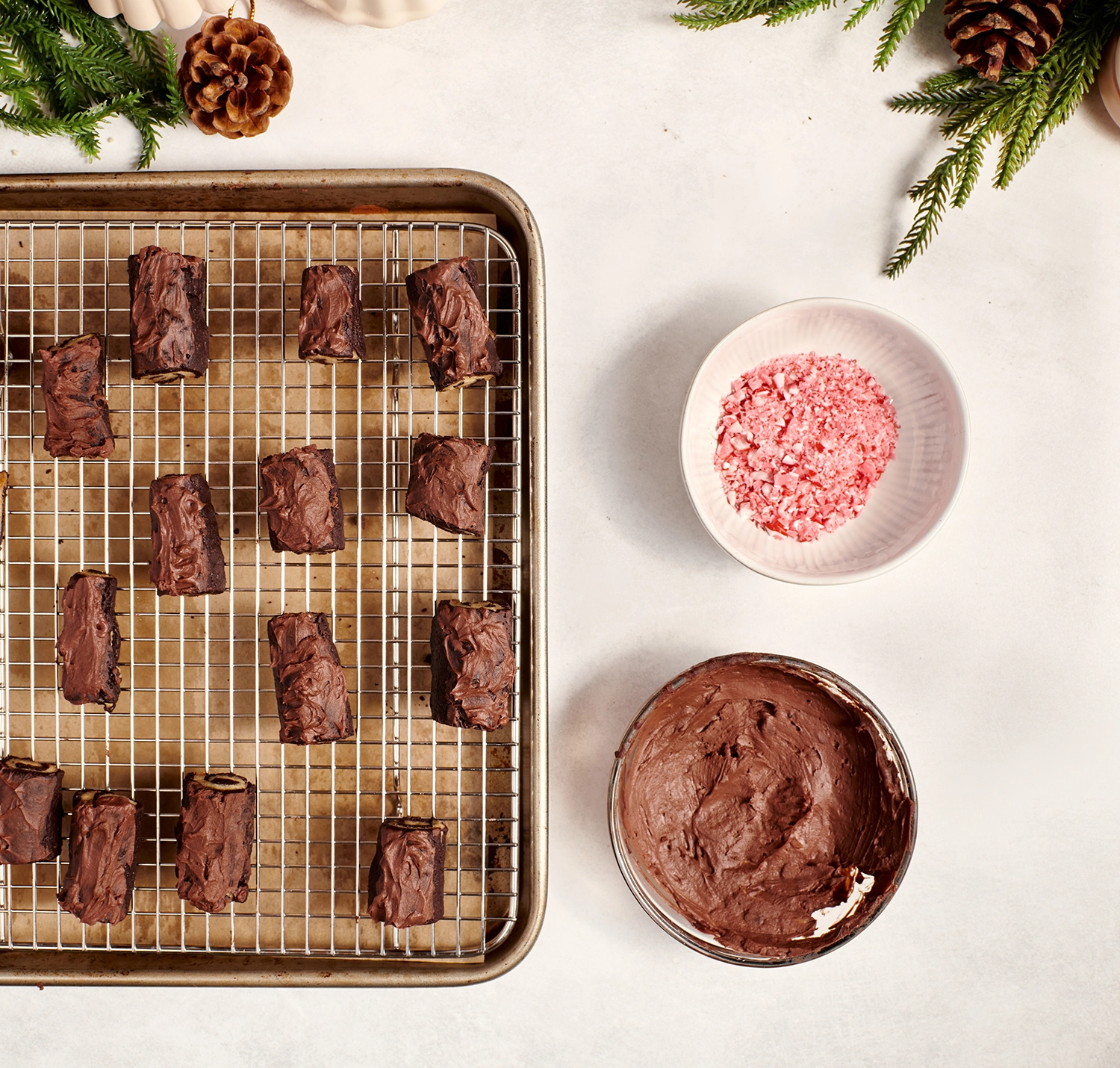 Chocolate-frosted cookies cool on a rack.