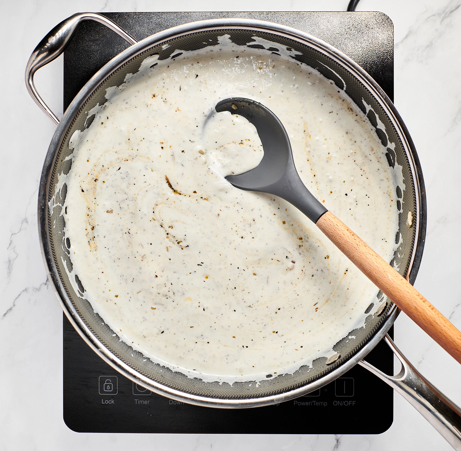 Blended Greek yogurt, cottage cheese and broth mixture in a skillet with the sautéed aromatics.